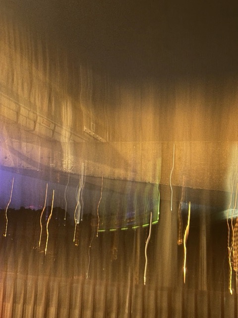 A blurry photo with yellow light shafts